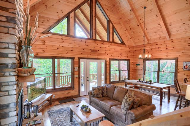 Spacious log cabin living room with panoramic views