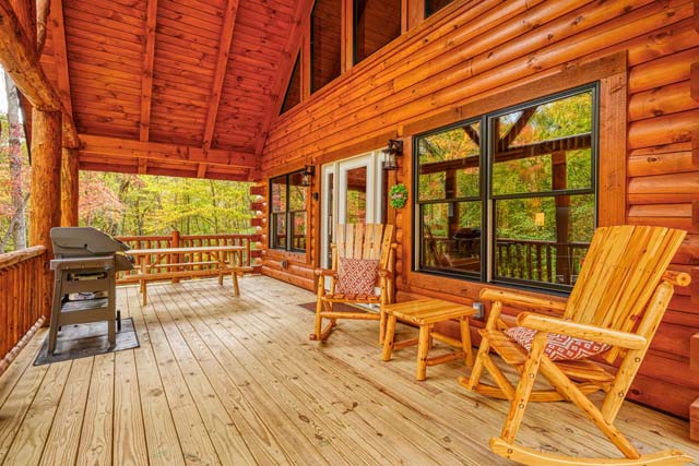 Inviting log cabin porch with rocking chairs